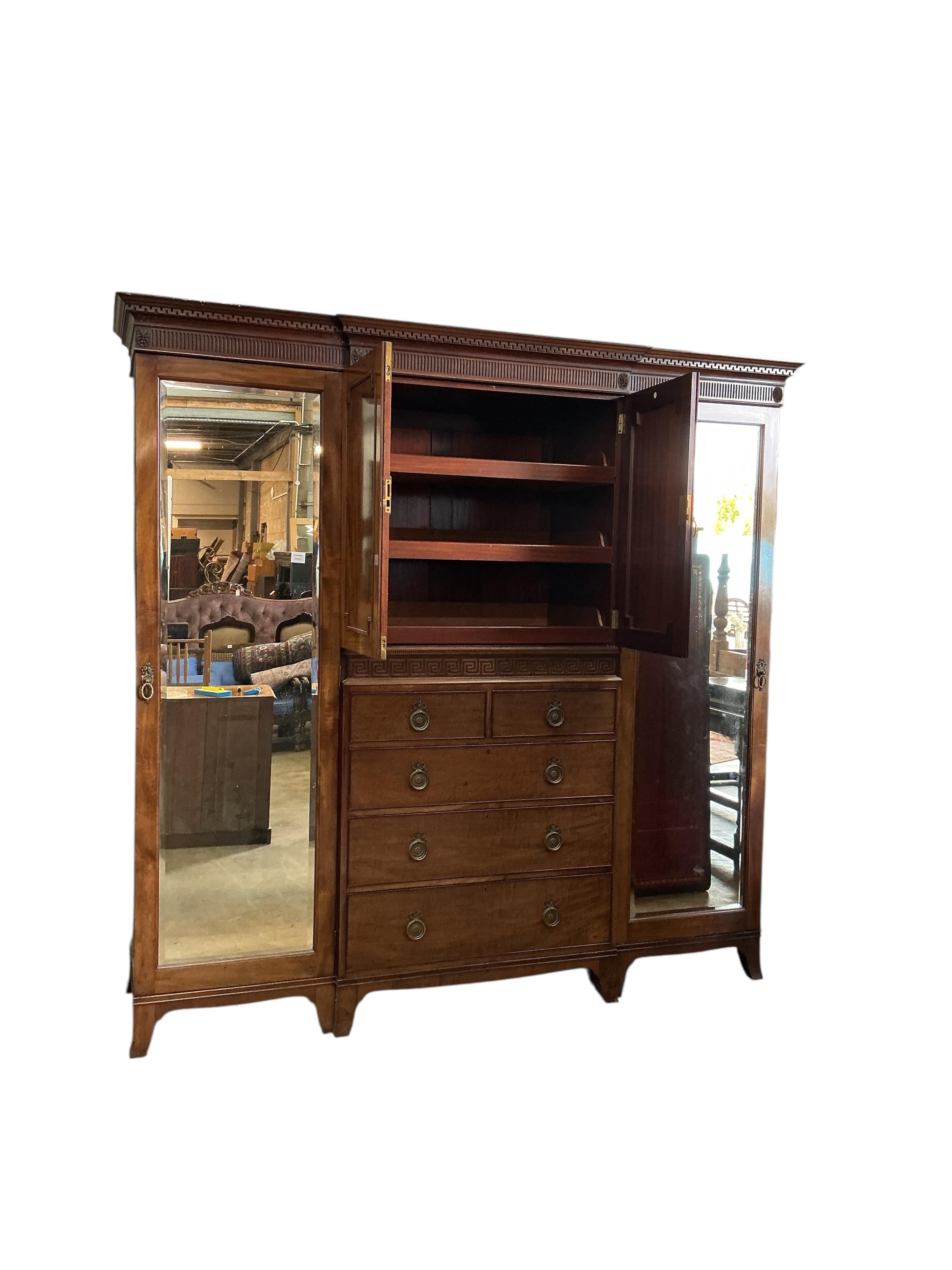 An early 20th century Heal & Son mahogany mirrored compactum wardrobe, width 224cm, depth 58cm, height 215cm